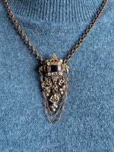 Load image into Gallery viewer, victorian necklace with intricate design on a blue textured background