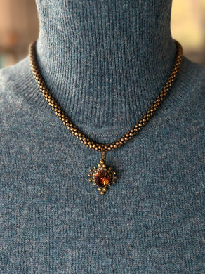Edwardian inspired Brass Necklace with a pendant on a mannequin wearing a blue sweater