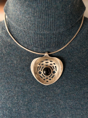 sterling silver Necklace with a heart-shaped pendant on a mannequin wearing a dark gray sweater.