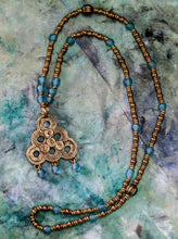 Load image into Gallery viewer, Berber Spiral Brass Pendant with Turquoise Recycled Glass beaded Long Necklace